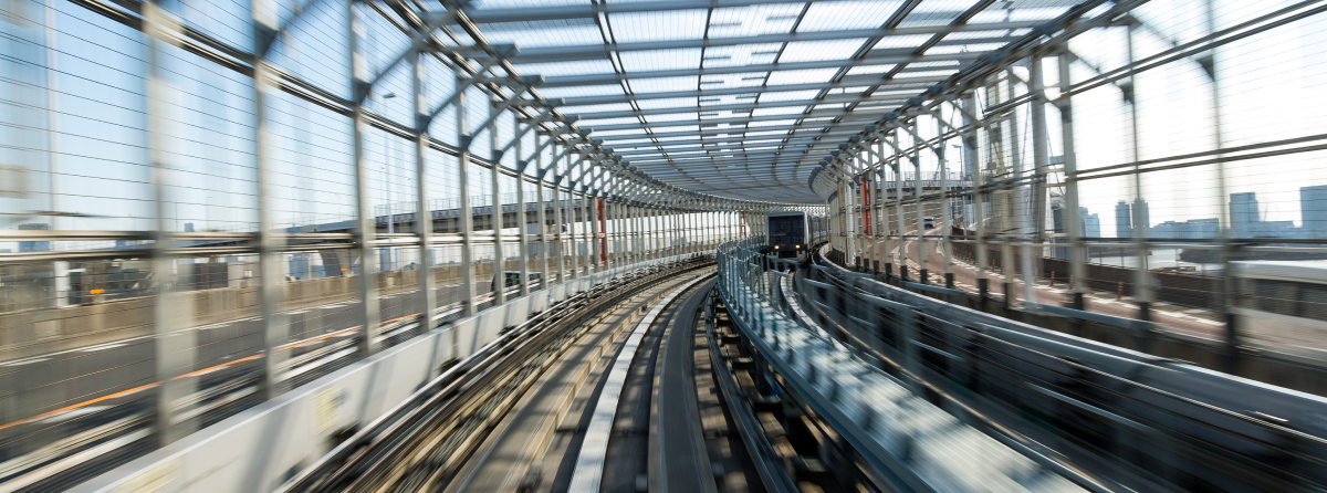 view of train riding inside of a train bridge