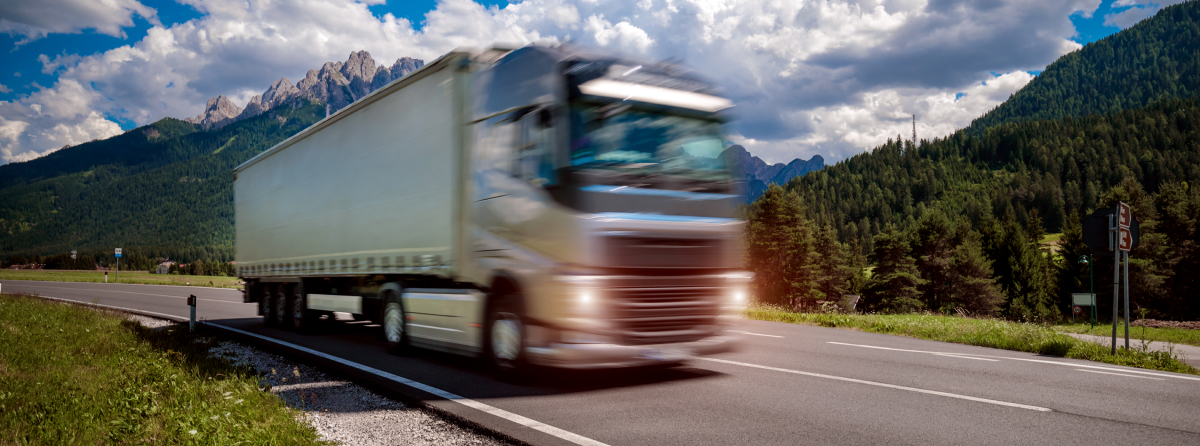 semi truck driving down a two lane highway